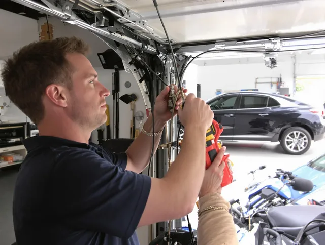 Portsmouth Garage Door Repair safety certified technician performing cable replacement in Portsmouth